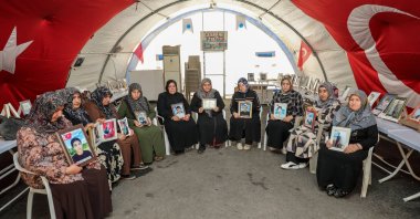 Mothers hold the photos of their children recruited by the PKK during their protest in Diyarbakır, southeastern Türkiye, May 9, 2026. (AA Photo)