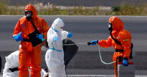 A passenger of the cruise ship MV Hondius, which was affected by a hantavirus outbreak, gets disinfected on the tarmac at Tenerife Sud airport, Canary Islands, Spain, May 10, 2026. (Rueters Photo)