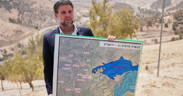 Israeli Finance Minister Bezalel Smotrich holds a map that shows the E1 settlement project during a press conference near the settlement of Maale Adumim, Israeli-occupied West Bank, Palestine, Aug. 14, 2025. (AP Photo)