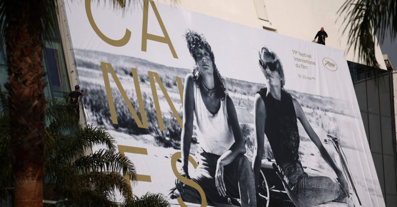 Workers hang the official poster of the 78th Cannes Film Festival on the facade of the Palais des Festivals, Cannes, France, May 10, 2026. (AFP Photo)