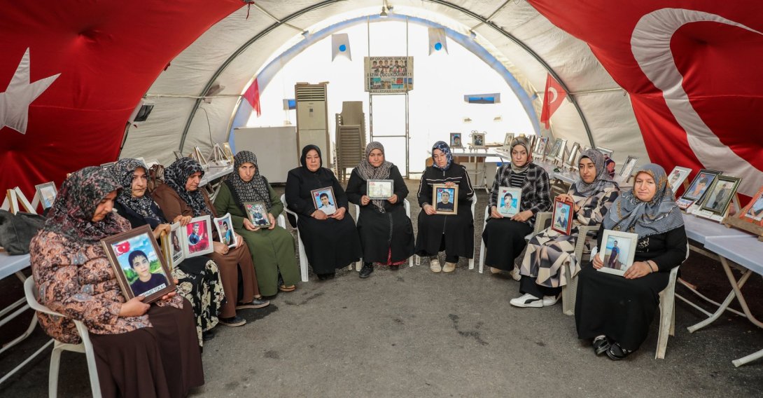 Mothers hold the photos of their children recruited by the PKK during their protest in Diyarbakır, southeastern Türkiye, May 9, 2026. (AA Photo)