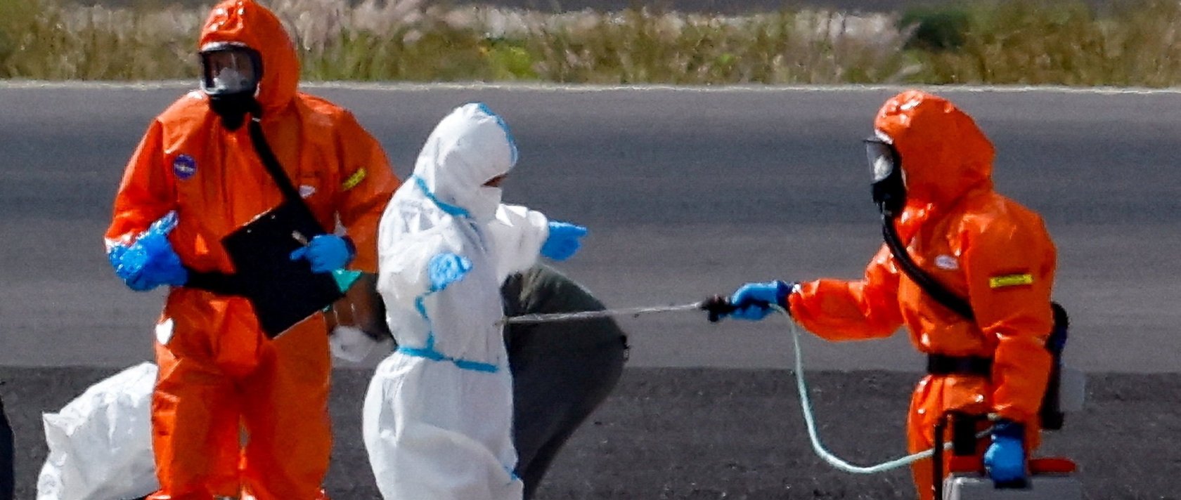 A passenger of the cruise ship MV Hondius, which was affected by a hantavirus outbreak, gets disinfected on the tarmac at Tenerife Sud airport, Canary Islands, Spain, May 10, 2026. (Rueters Photo)