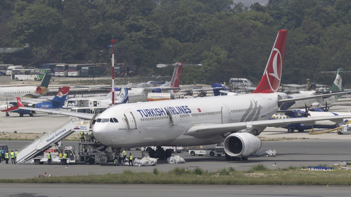 Ground staff collect an emergency ladder from a Turkish Airlines aircraft at Tribhuvan International Airport in Kathmandu, Nepal, May 11, 2026. (EPA Photo)