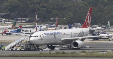Ground staff collect an emergency ladder from a Turkish Airlines aircraft at Tribhuvan International Airport in Kathmandu, Nepal, May 11, 2026. (EPA Photo)