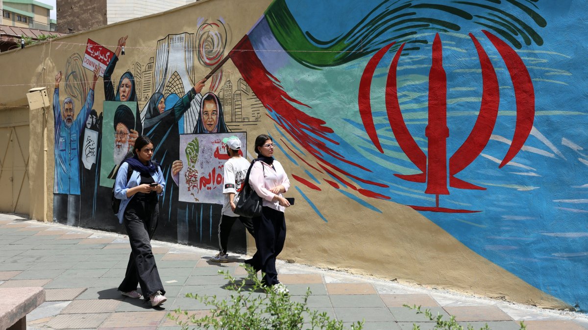 Iranians walk next to an anti-US and Israel mural in a street in Tehran, Iran, May 8, 2026. (EPA Photo)