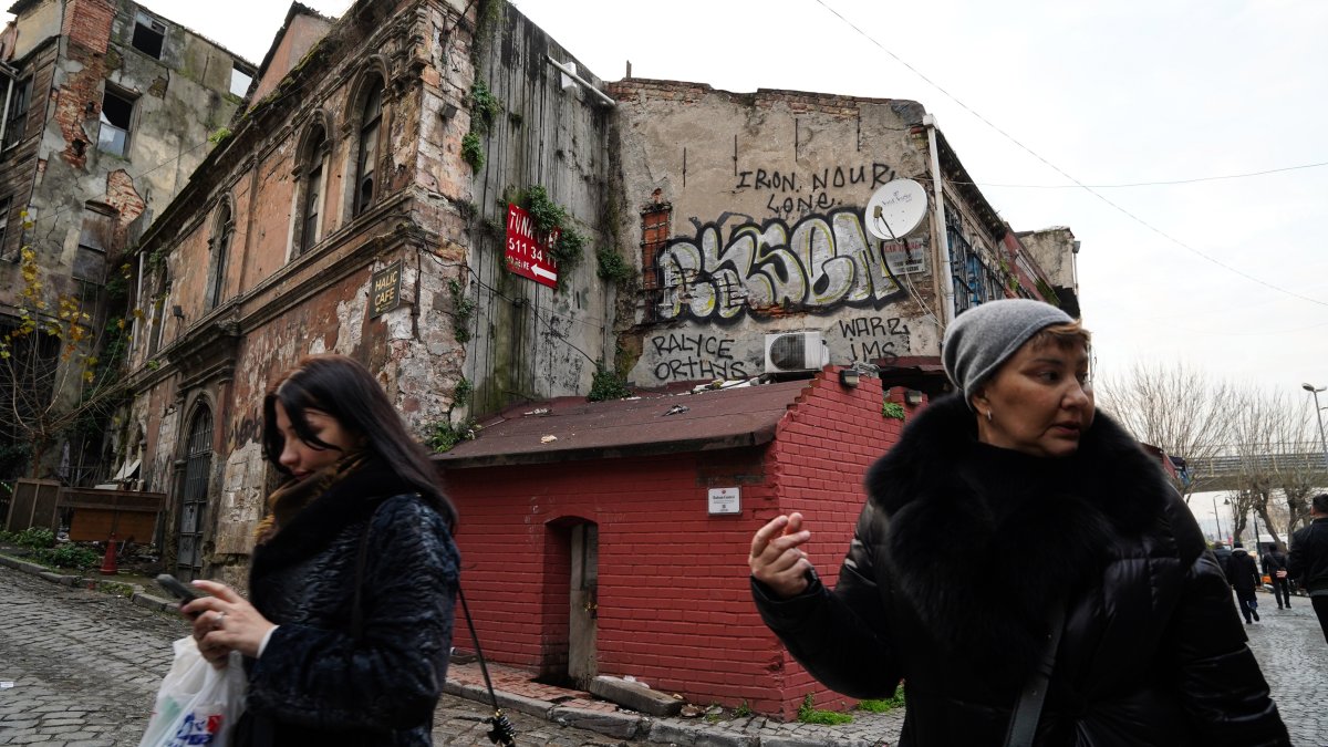Two women walk past a historic alley in Istanbul, Türkiye, Jan. 14, 2026. (Getty Images Photo)