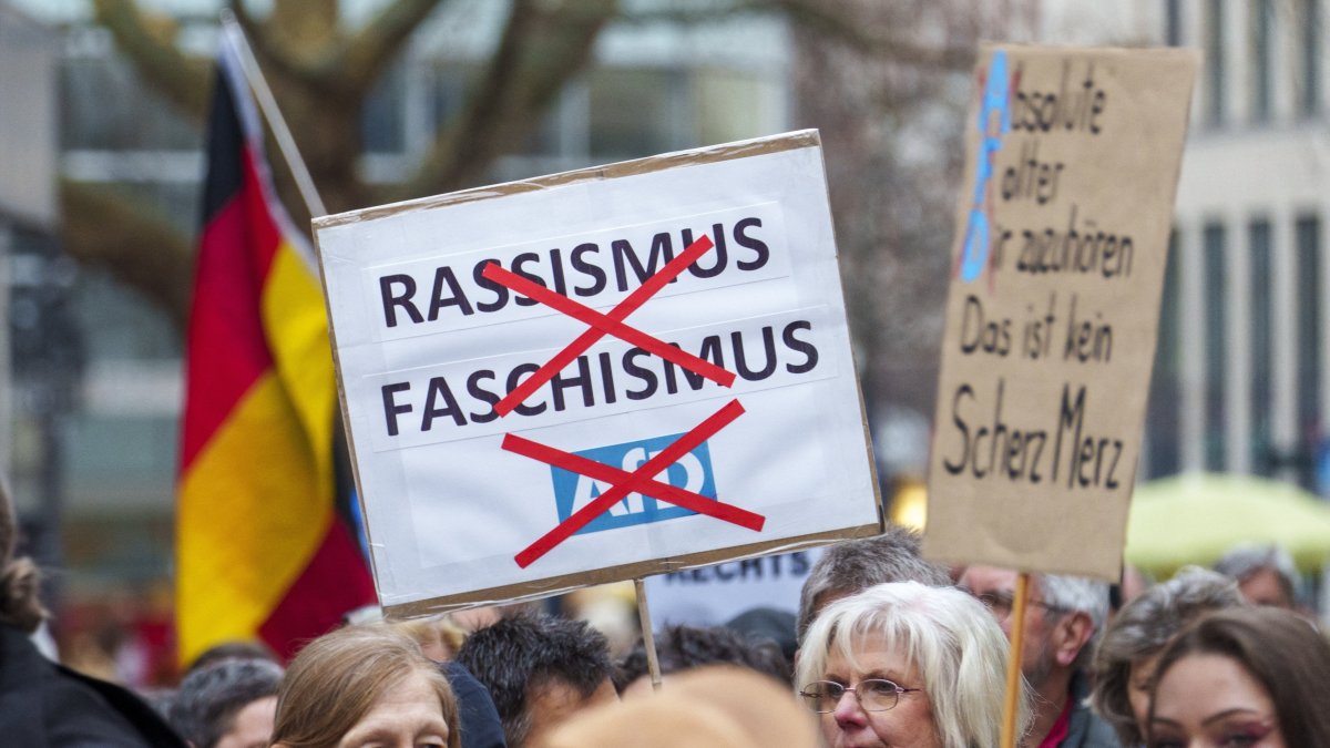 A poster rejecting "racism, fascism, AfD" can be seen at the "human chain for diversity" in Hesse, Wiesbaden, Germany, Feb. 22, 2025. (dpa Picture-Alliance via AFP File Photo))