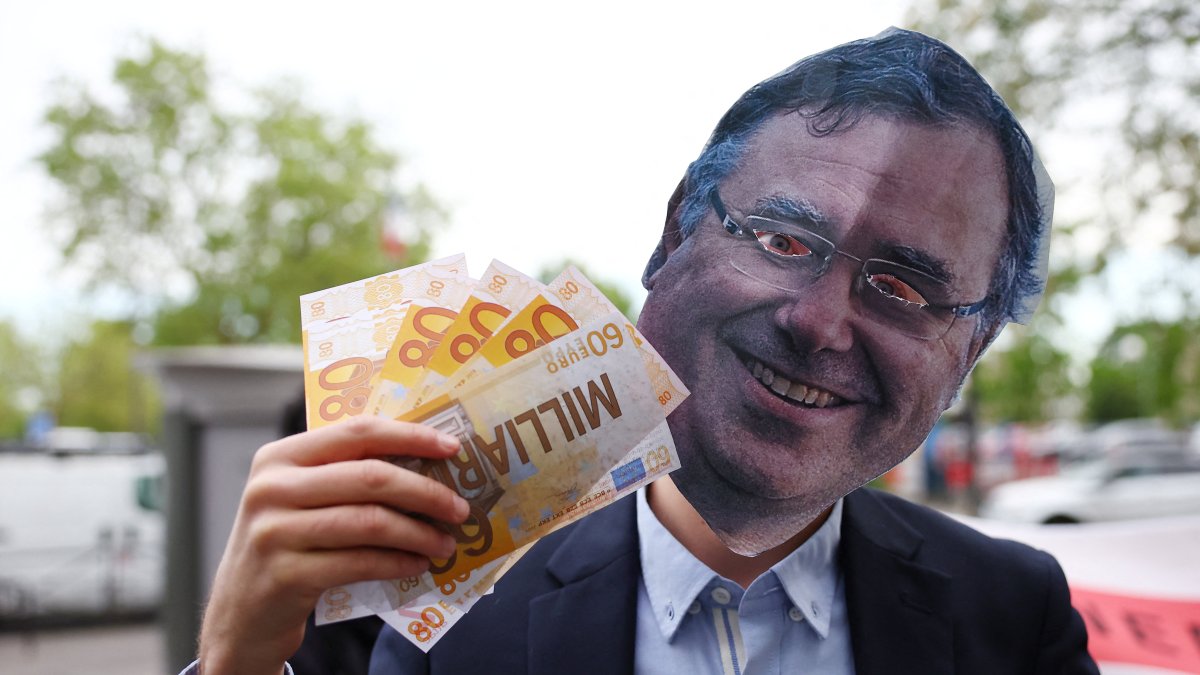 An activist wearing a mask depicting Patrick Pouyanne, Chairman and CEO of TotalEnergies, attends a staged protest action in front of a petrol station to denounce the profits made by fossil fuel multinationals on the occasion of the publication of TotalEnergies' first quarter 2026 financial results, in Paris, France, April 29, 2026. (Reuters Photo)