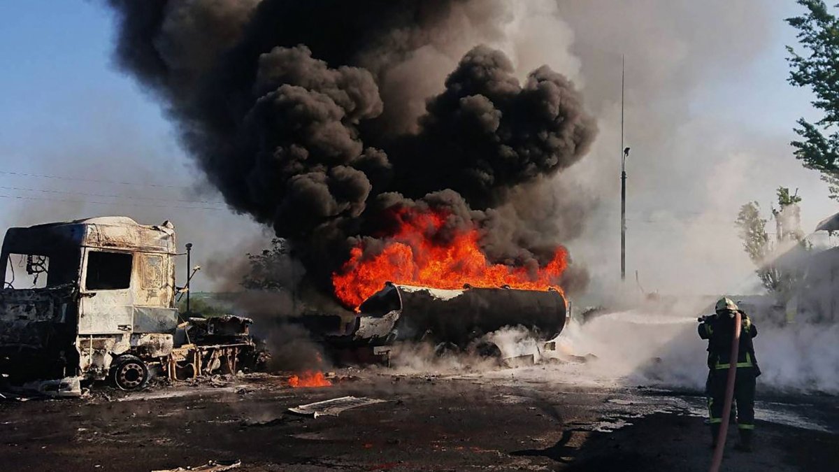 This handout photograph taken and released by the State Emergency Service of Ukraine shows a firefighter holding a hose to attempt to extinguish a fire at the site of a Russian air attack in an undisclosed area of the Dnipro region, Ukraine, May 12, 2026. (AFP Photo) 