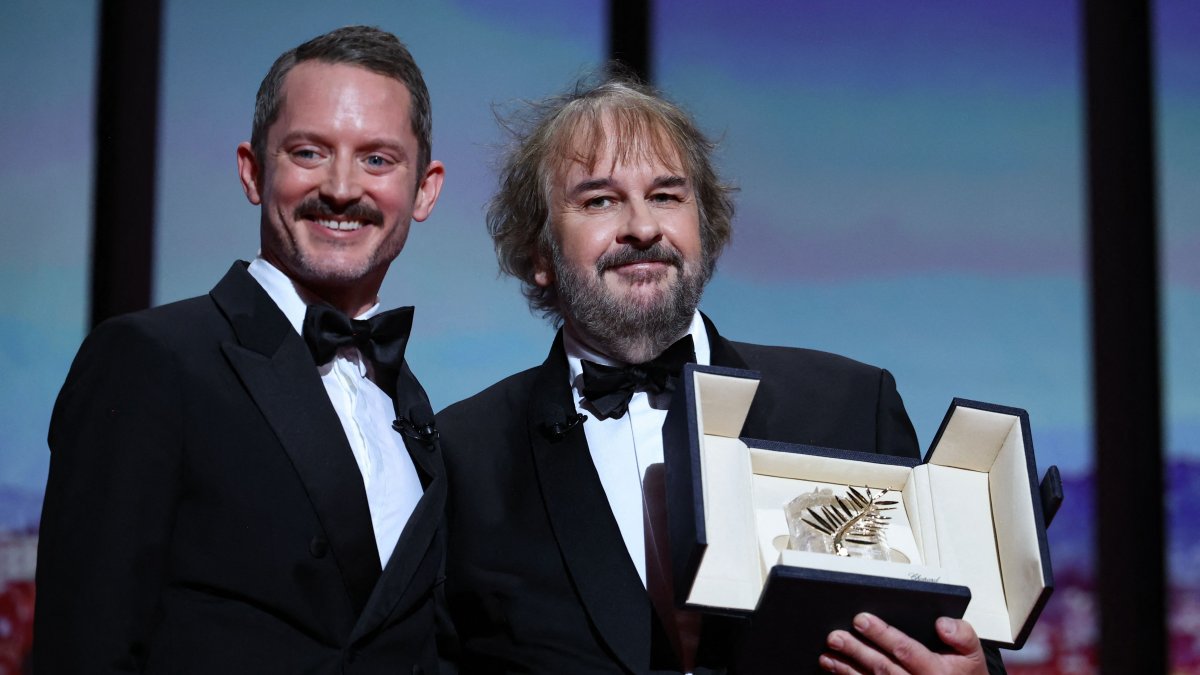 New Zealand director, screenwriter and producer Peter Jackson (R) receives his Honorary Palme d'Or from U.S. actor Elijah Wood during the Opening Ceremony at the 79th edition of the Cannes Film Festival in Cannes, southern France, May 12, 2026. (AFP Photo)