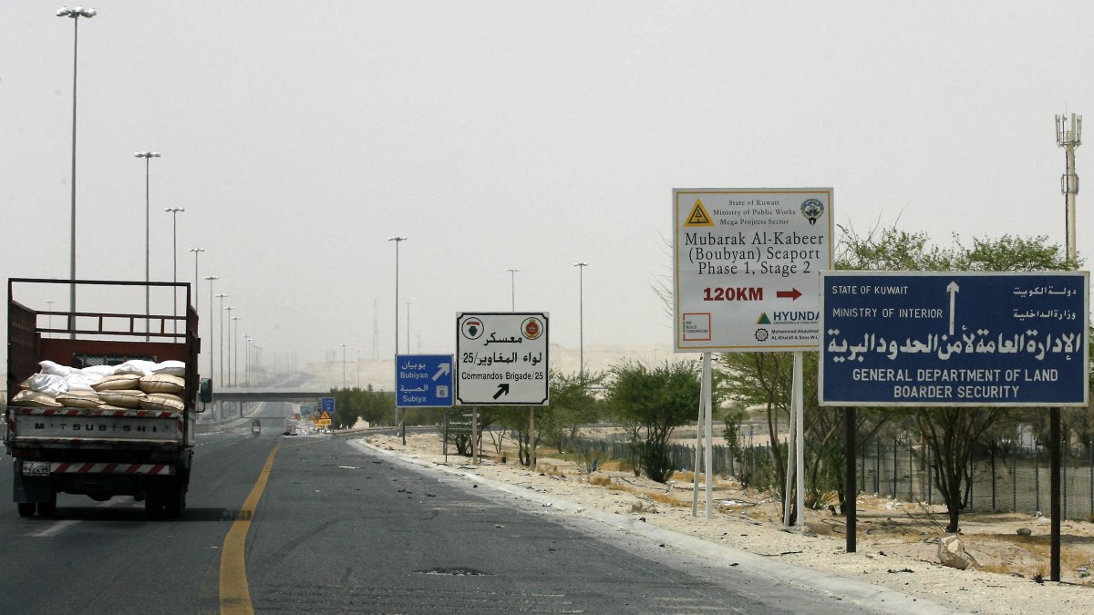 A truck drives past a road sign giving directions to the construction site of the Mubarak al-Kabir port on Bubiyan Island on the road to Subiya, 60 kms north of Kuwait City, Aug. 15, 2011. (AFP File Photo)