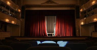 A view of a theater interior with a stage and rows of seats. (Shutterstock Photo)