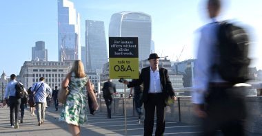 Workers walk towards the City of London financial district as they cross London Bridge during the morning rush hour in London, U.K., Sept. 8, 2021. (Reuters Photo)