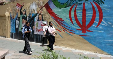Iranians walk next to an anti-US and Israel mural in a street in Tehran, Iran, May 8, 2026. (EPA Photo)