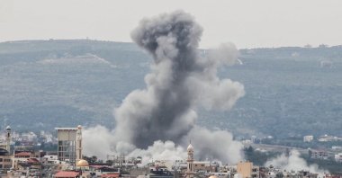 A photograph taken from the southern area of Tyre shows smoke rising from the site of an Israeli airstrike that targeted the area of Ras Al-Ain, Lebanon, May 12, 2026. (AFP Photo)