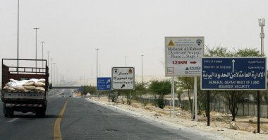 A truck drives past a road sign giving directions to the construction site of the Mubarak al-Kabir port on Bubiyan Island on the road to Subiya, 60 kms north of Kuwait City, Aug. 15, 2011. (AFP File Photo)
