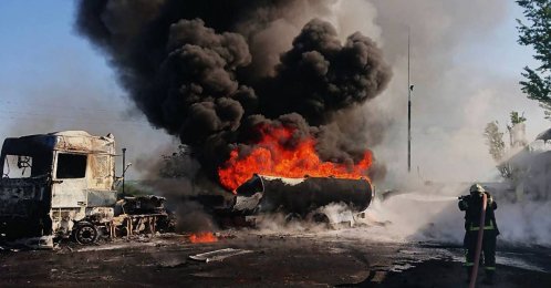 This handout photograph taken and released by the State Emergency Service of Ukraine shows a firefighter holding a hose to attempt to extinguish a fire at the site of a Russian air attack in an undisclosed area of the Dnipro region, Ukraine, May 12, 2026. (AFP Photo) 