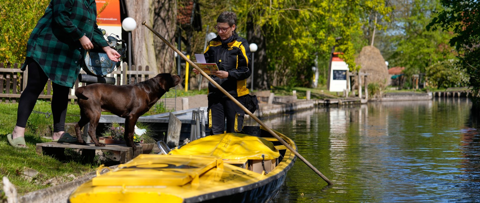 Mailperson Andrea Bunar delivers mail from a boat during the first tour of the summer in the village of Lehde, Luebbenau, Germany, April 29, 2026. (AP Photo)