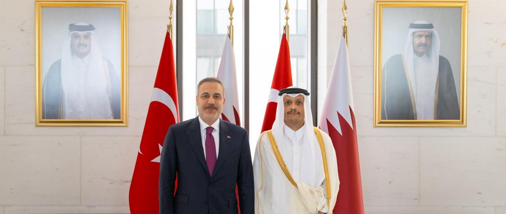 Turkish FM Hakan Fidan (L) poses with Qatari counterpart Mohammed bin Abdulrahman bin Jassim bin Jaber Al Thani during their meeting, in Doha, Qatar, May 12, 2026. (AA Photo) 