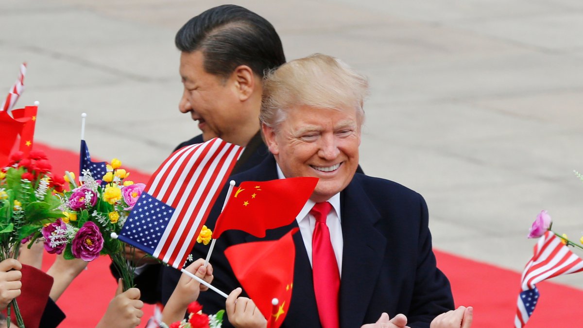 U.S. President Donald Trump (R) and Chinese President Xi Jinping are greeted by children waving flowers and flags during a welcome ceremony at the Great Hall of the People, Beijing, China, Nov. 9, 2017. (AP Photo)