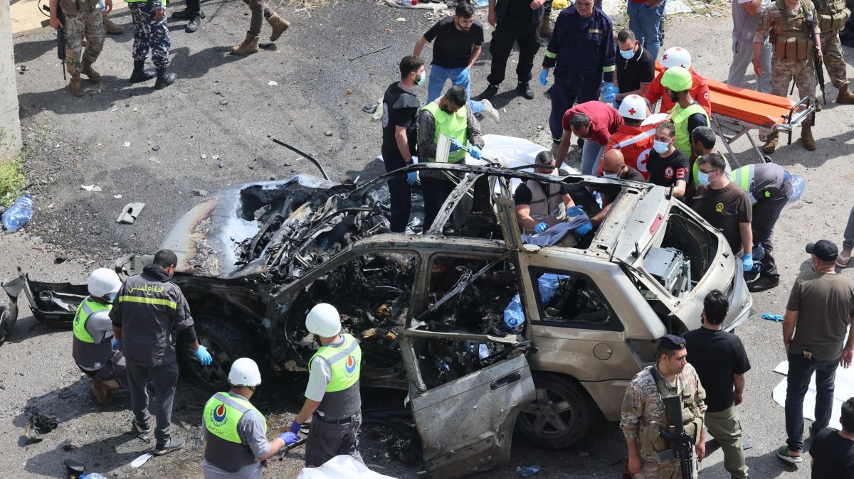 Lebanese rescuers and soldiers inspect the wreckage of a vehicle that was hit in an Israeli strike in Jiyeh town, south of Beirut, Lebanon, May 13, 2026. (EPA Photo)