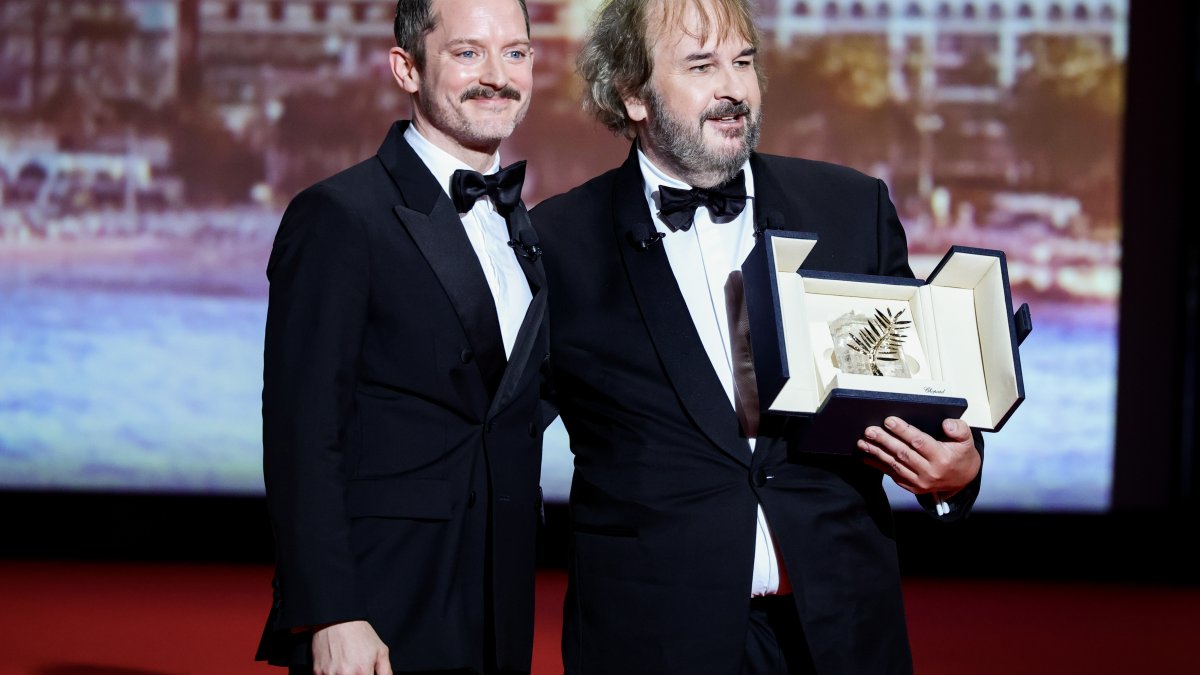 Peter Jackson (R) receives the Honorary Palme d'Or from Elijah Wood on stage during the opening ceremony of the 79th annual Cannes Film Festival at Palais des Festivals, Cannes, France, May 12, 2026. (Getty Images Photo)