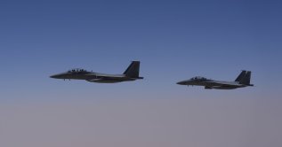 Two Royal Saudi Air Force F-15s are seen over Saudi airspace, May 13, 2025. (AP Photo)
