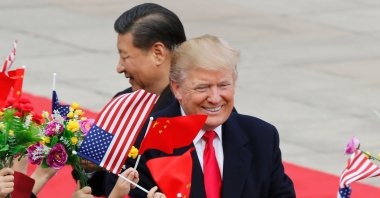 U.S. President Donald Trump (R) and Chinese President Xi Jinping are greeted by children waving flowers and flags during a welcome ceremony at the Great Hall of the People, Beijing, China, Nov. 9, 2017. (AP Photo)