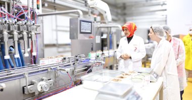 Fatma Meriç Yılmaz, the head of the Turkish Red Crescent (Kızılay), attends a presentation on the canning process of Eid al-Adha meat, Izmir, Türkiye, May 12, 2026. (Courtesy of Kızılay)