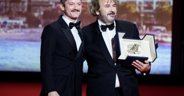 Peter Jackson (R) receives the Honorary Palme d'Or from Elijah Wood on stage during the opening ceremony of the 79th annual Cannes Film Festival at Palais des Festivals, Cannes, France, May 12, 2026. (Getty Images Photo)