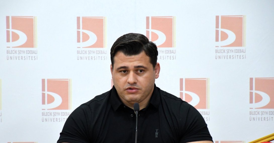 European wrestling champion Rıza Kayaalp speaks during a talk titled “Listen to the Path to Success from a Champion” organized by Bilecik Şeyh Edebali University Student Clubs Coordination Office at the Faculty of Economics and Administrative Sciences conference hall, Bilecik, Türkiye, May 12, 2026. (AA Photo)

