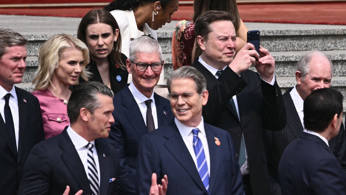 U.S. Secretary of Defense Pete Hegseth (bottom L) speaks with U.S. Treasury Secretary Scott Bessent (bottom center R), as Tesla and SpaceX CEO Elon Musk (top R) uses his phone and Apple CEO Tim Cook (C) looks on at a welcome ceremony for US President Donald Trump at the Great Hall of the People in Beijing, China, May 14, 2026. (AFP Photo)