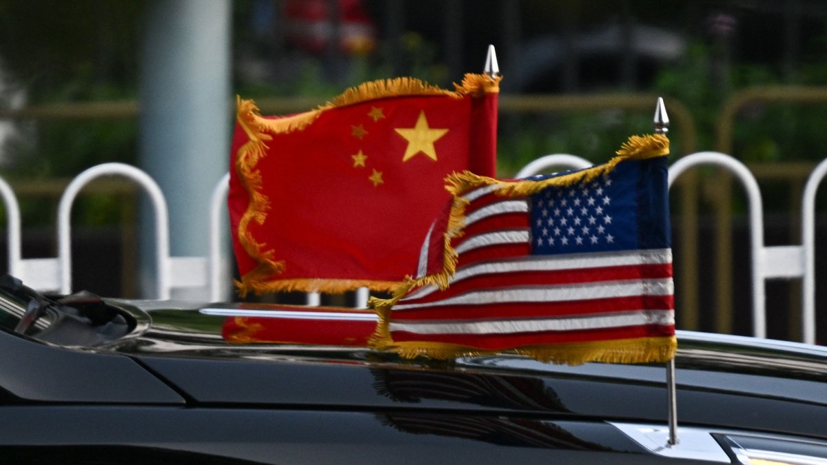 The U.S. and China flags are seen on a vehicle in the motorcade of U.S. President Donald Trump as it leaves the hotel in Beijing, China, May 14, 2026. (AFP Photo)