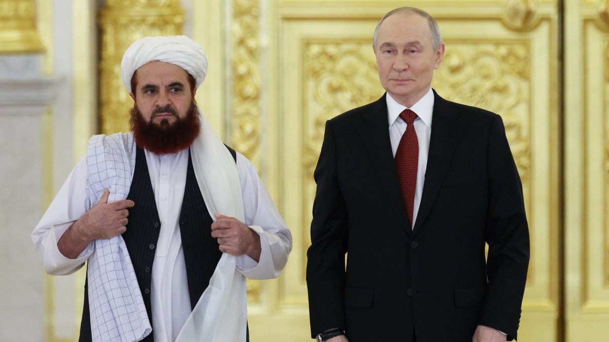 Russian President Vladimir Putin (R) and the Afghan Ambassador to Russia, Gul Hassan Hassan, attend a ceremony in Moscow, Russia, Jan. 15, 2026. (AP Photo)