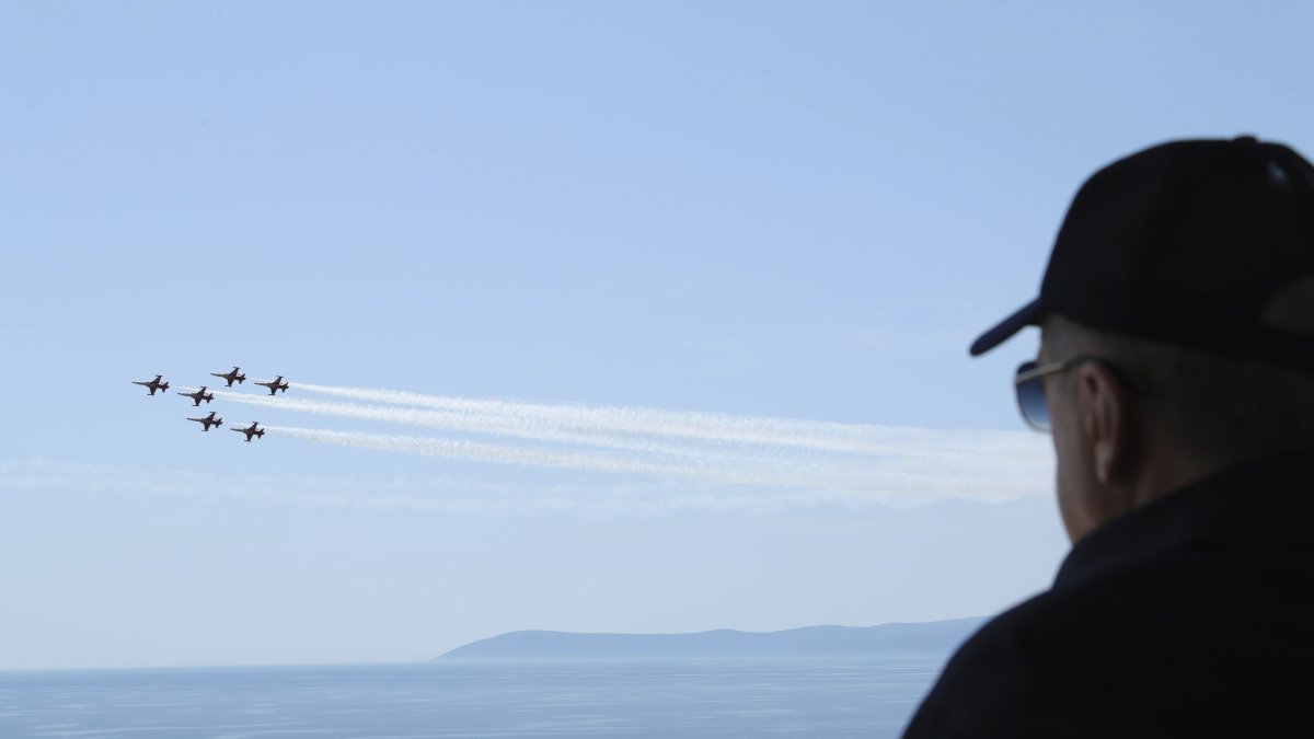 President Recep Tayyip Erdoğan watches jet fighters fly past during the final day of military exercises that were taking place in Seferihisar near Izmir, on Türkiye's Aegean coast, June 9, 2022. (AP Photo)