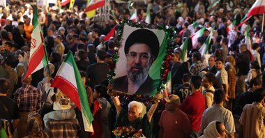 A man holds a portrait of Iran's supreme leader Ayatollah Mojtaba Khamenei while attending the farewell ceremony of Iran's national football team ahead of their departure for the 2026 FIFA World Cup, Tehran, Iran, May 13, 2026. (AFP Photo)