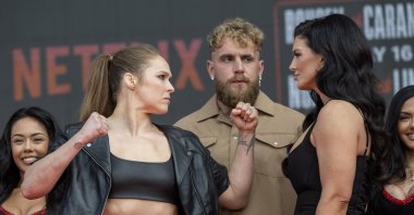 (L-R) Ronda Rousey, Jake Paul and Gina Carano as the fighters face off during a press conference at the Intuit Dome, Inglewood, U.S., March 10, 2026. (Getty Images Photo)