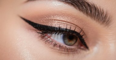 A close-up view of an eye, featuring a sharp winged eyeliner, eyeshadow and defined lashes. (Shutterstock Photo)