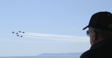 President Recep Tayyip Erdoğan watches jet fighters fly past during the final day of military exercises that were taking place in Seferihisar near Izmir, on Türkiye's Aegean coast, June 9, 2022. (AP Photo)