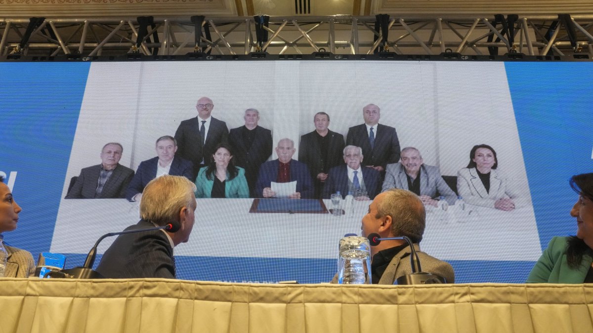 DEM Party members attend a news conference against the backdrop of a photo of the jailed PKK leader Abdullah Öcalan (C), Istanbul, Türkiye, Feb, 27, 2025. (AP Photo)