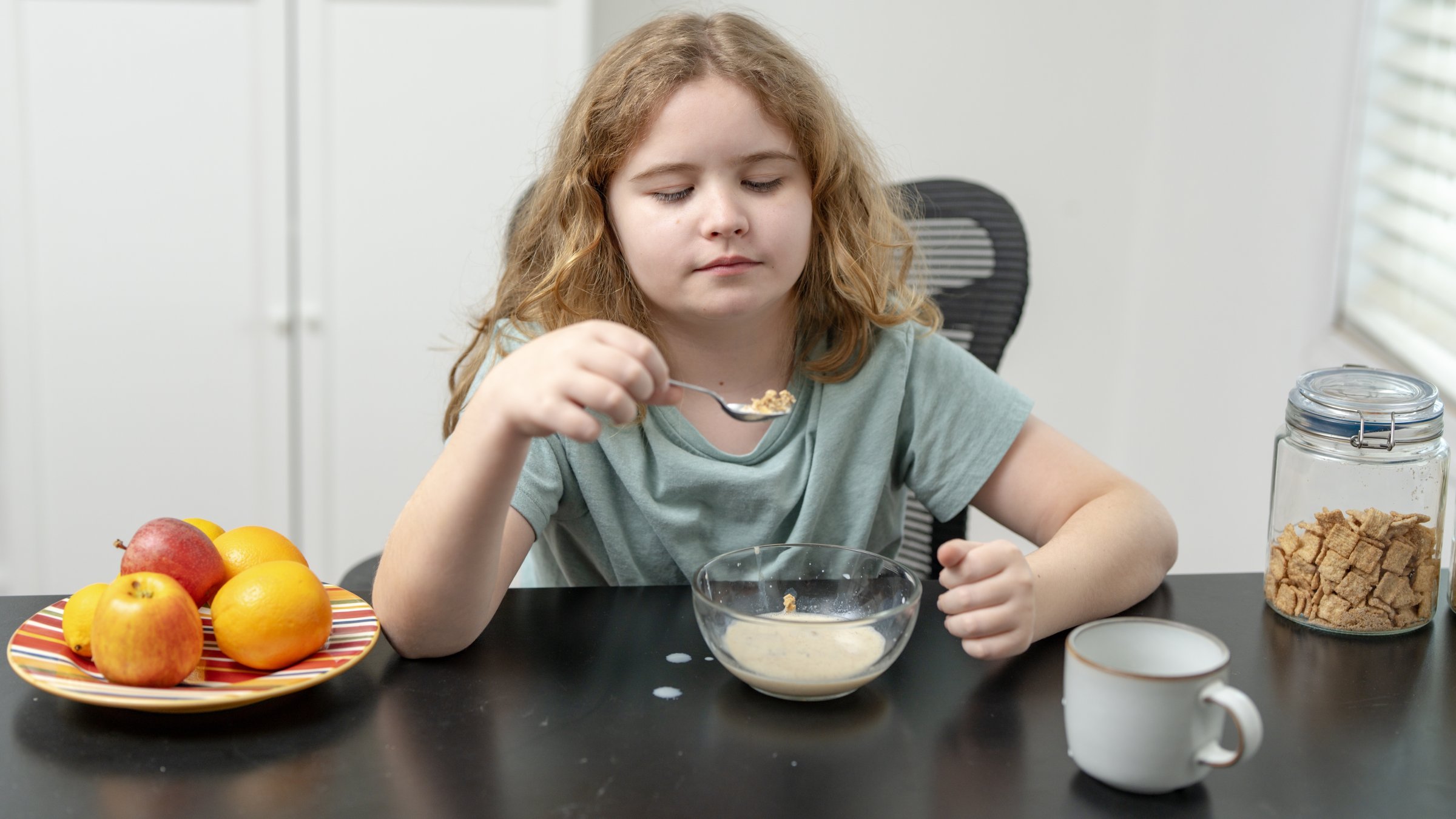 A child eats breakfast with cereal and milk at home as experts warn of rising food allergies among children. (Shutterstock Photo) 