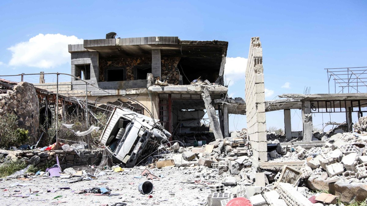 The debris of a destroyed building and vehicle litters the ground following a Jordanian strike on reported drugs and weapons storage facilities in the village of Busan, in the southern province of Suwayda, May 2, 2026. (AFP Photo)