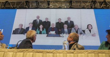 DEM Party members attend a news conference against the backdrop of a photo of the jailed PKK leader Abdullah Öcalan (C), Istanbul, Türkiye, Feb, 27, 2025. (AP Photo)