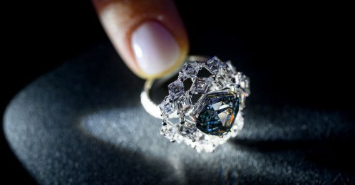 A photograph shows a triangular-shaped fancy vivid blue-green diamond weighing 5.50 carats, known as "The Ocean Dream," displayed during a press preview at Christie’s auction house, Geneva, Switzerland, May 7, 2026. (AFP Photo)