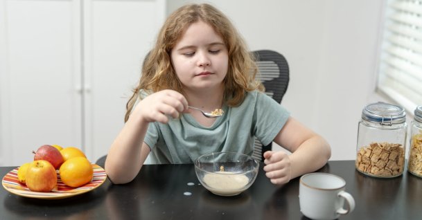 A child eats breakfast with cereal and milk at home as experts warn of rising food allergies among children. (Shutterstock Photo) 