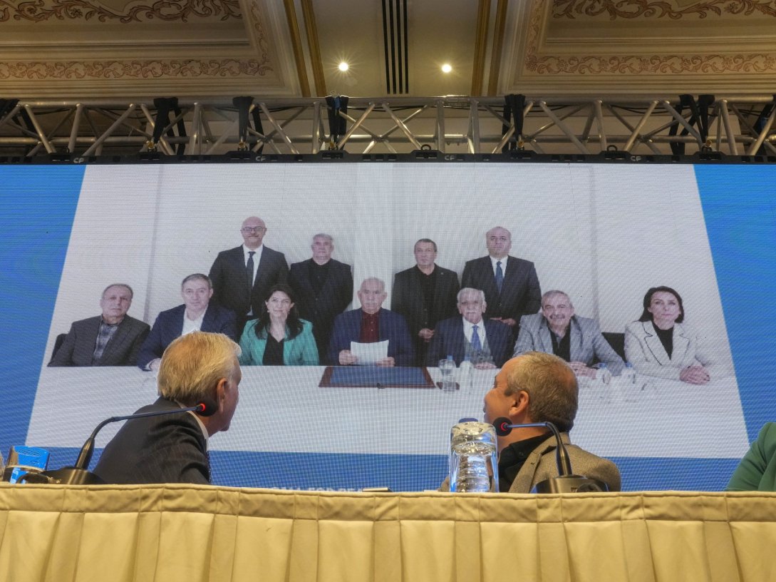 DEM Party members attend a news conference against the backdrop of a photo of the jailed PKK leader Abdullah Öcalan (C), Istanbul, Türkiye, Feb, 27, 2025. (AP Photo)