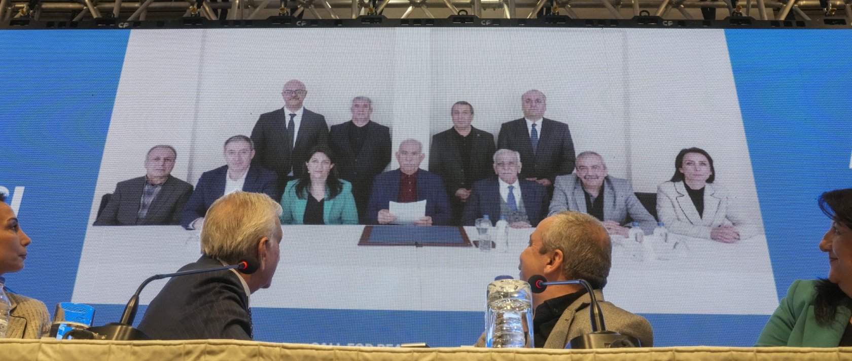 DEM Party members attend a news conference against the backdrop of a photo of the jailed PKK leader Abdullah Öcalan (C), Istanbul, Türkiye, Feb, 27, 2025. (AP Photo)