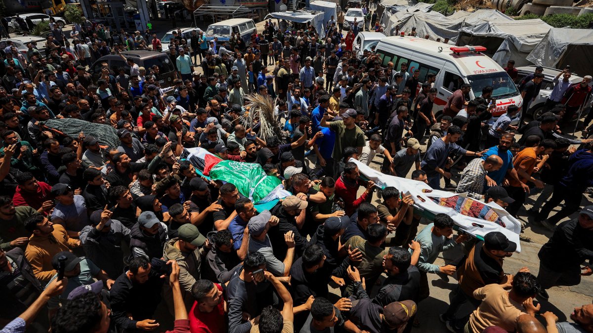 People carry bodies identified by mourners as Hamas' military wing commander Izz al-Din al-Haddad, his wife and his daughter, who were killed in an Israeli strike a day earlier, during a funeral, in Gaza City, May 16, 2026. (Reuters Photo)