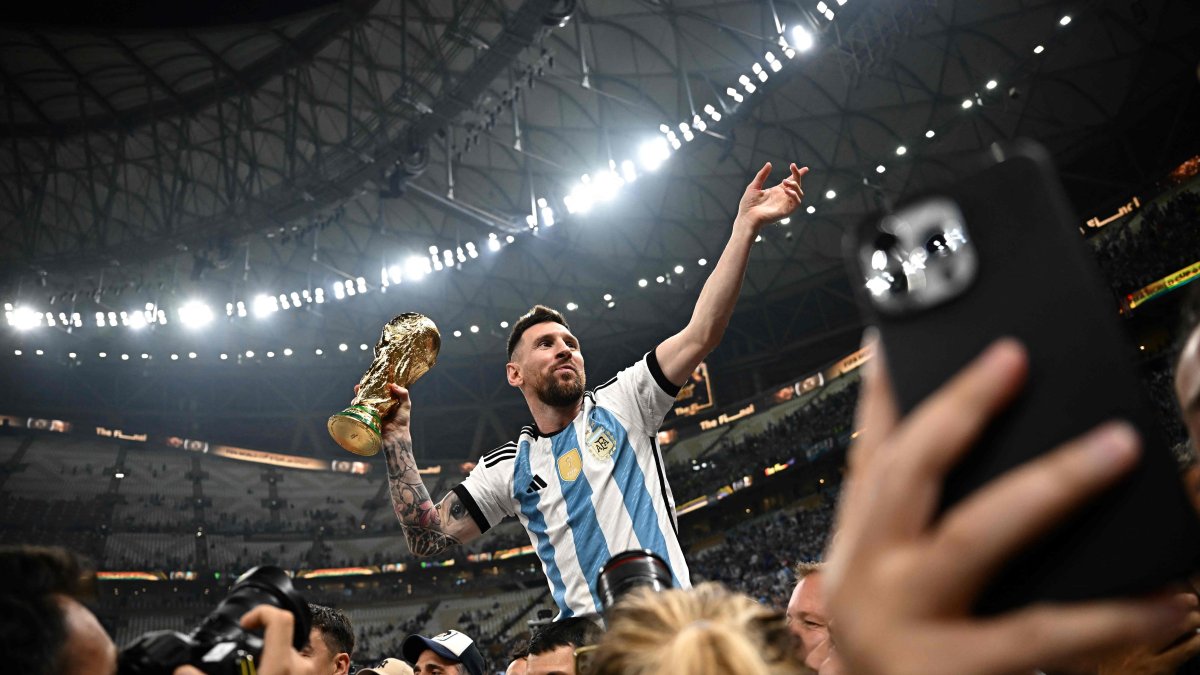 Argentina's captain and forward #10 Lionel Messi (R) holds the FIFA World Cup Trophy following the trophy ceremony after Argentina won the Qatar 2022 World Cup final against France at Lusail Stadium in Lusail, Doha, Qatar, Dec. 18, 2022. (AFP Photo)