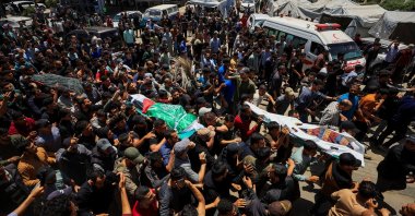 People carry bodies identified by mourners as Hamas' military wing commander Izz al-Din al-Haddad, his wife and his daughter, who were killed in an Israeli strike a day earlier, during a funeral, in Gaza City, May 16, 2026. (Reuters Photo)